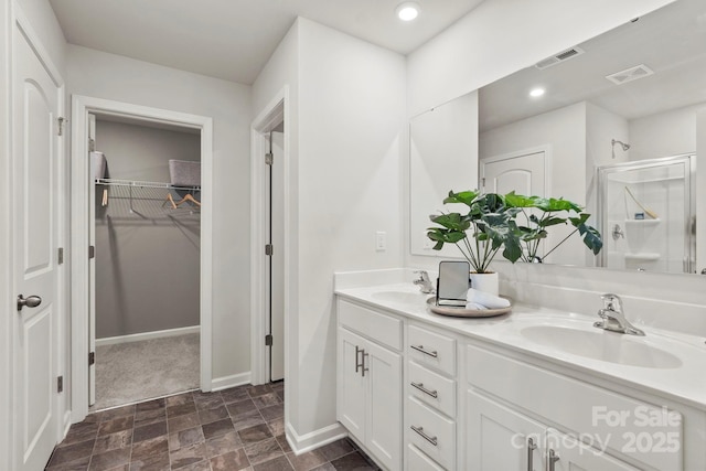 bathroom featuring vanity and a shower with shower door