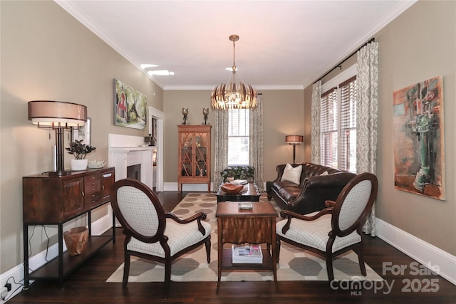 sitting room featuring dark hardwood / wood-style flooring, ornamental molding, and a chandelier