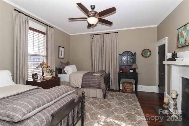 bedroom featuring ceiling fan, dark hardwood / wood-style flooring, and crown molding