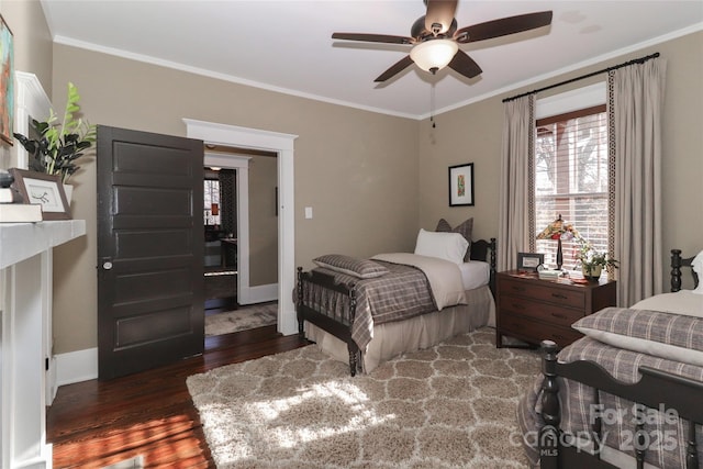 bedroom with dark hardwood / wood-style flooring, ceiling fan, and crown molding