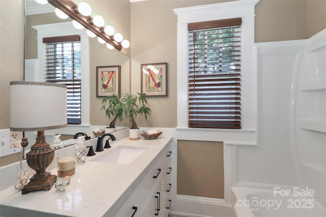 bathroom with a bathtub, plenty of natural light, and vanity