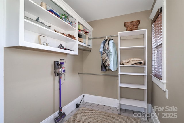 walk in closet featuring light tile patterned floors