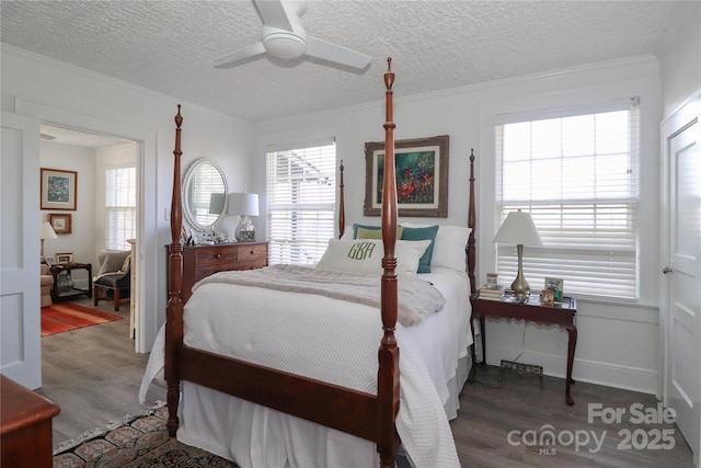 bedroom featuring a textured ceiling, crown molding, ceiling fan, and dark wood-type flooring