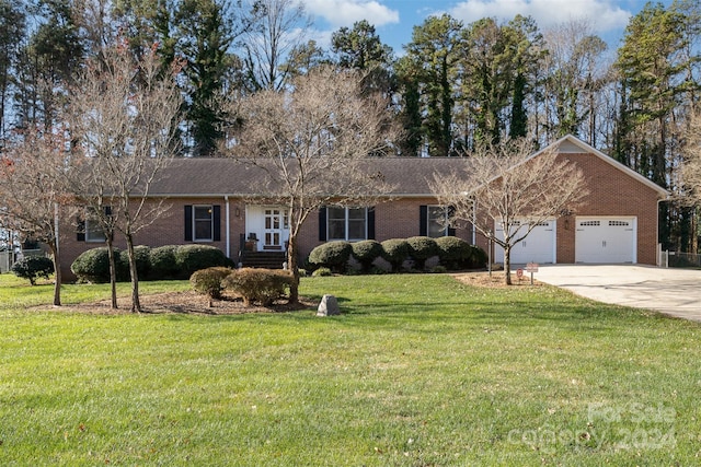 ranch-style house featuring a front lawn and a garage