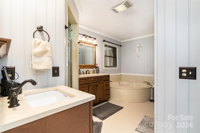 bathroom featuring tile patterned floors, a textured ceiling, vanity, crown molding, and a bathing tub