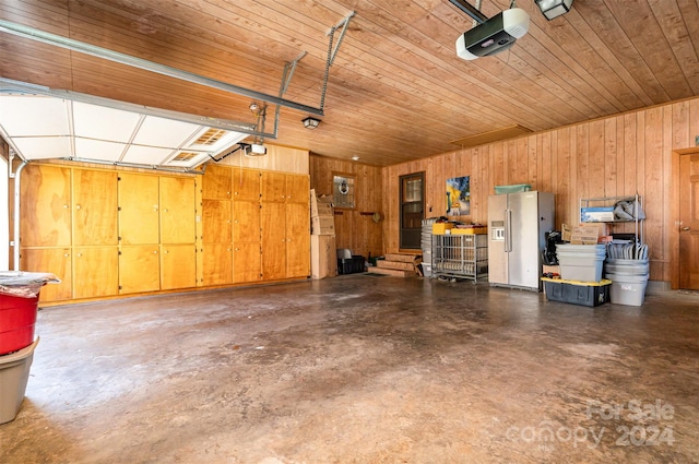 garage with wood ceiling, high quality fridge, wood walls, and a garage door opener