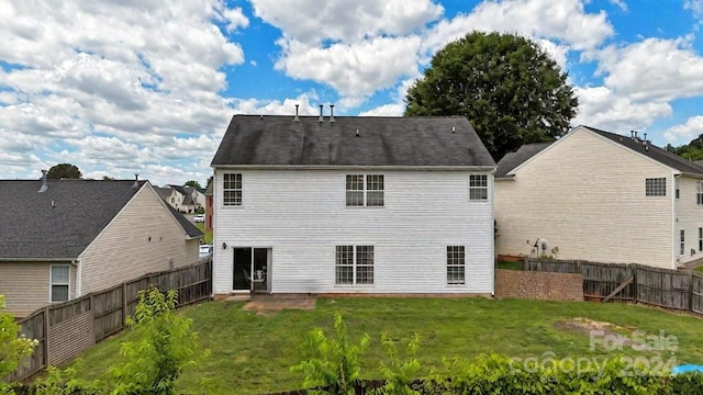 rear view of property with a yard