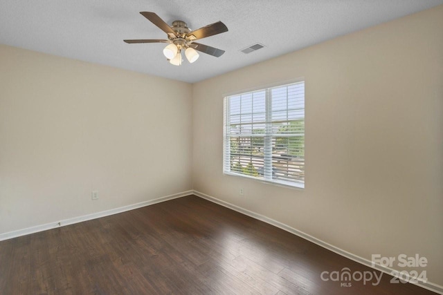 spare room with ceiling fan, dark hardwood / wood-style flooring, and a textured ceiling