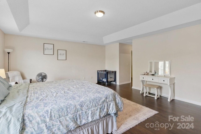 bedroom with dark hardwood / wood-style floors