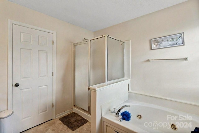 bathroom featuring a textured ceiling and plus walk in shower