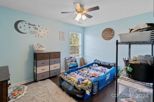 bedroom featuring a textured ceiling, hardwood / wood-style flooring, and ceiling fan