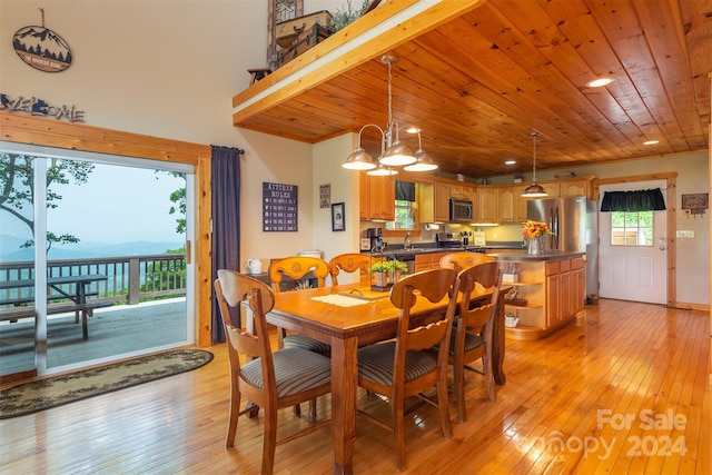 dining room with a chandelier, light hardwood / wood-style floors, and wooden ceiling