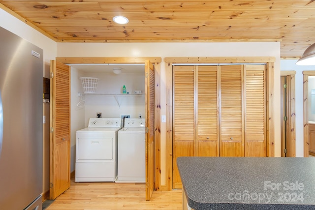 washroom featuring washer and dryer, wooden ceiling, and light wood-type flooring