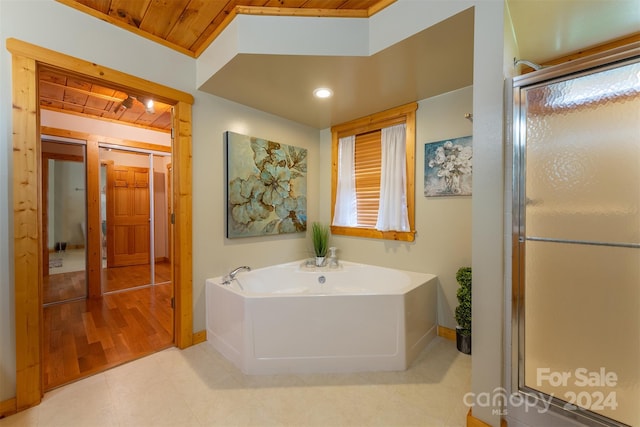 bathroom with hardwood / wood-style floors, independent shower and bath, and wood ceiling