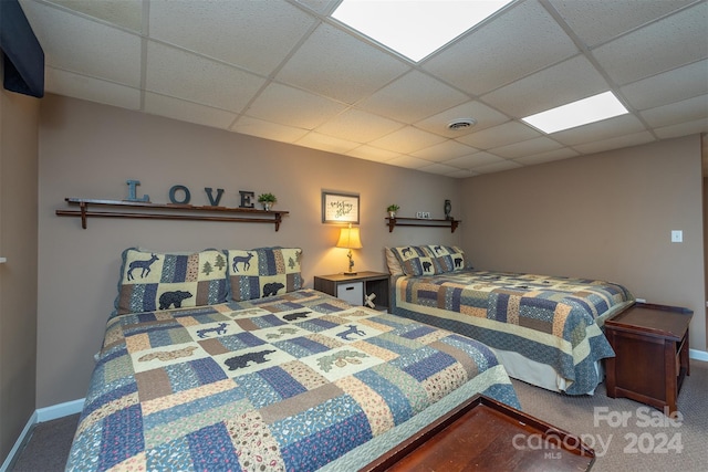 carpeted bedroom featuring a paneled ceiling