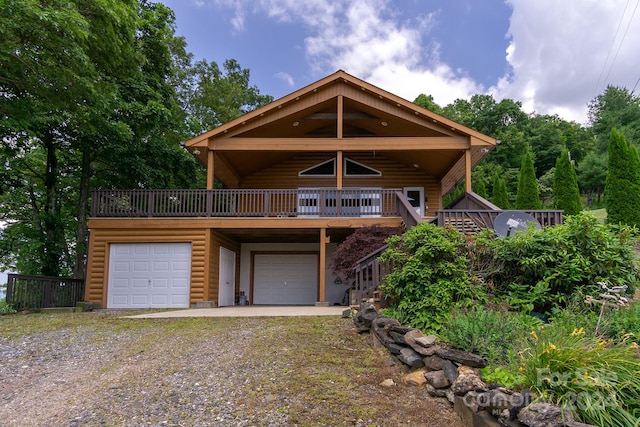 view of front of property with a wooden deck and a garage