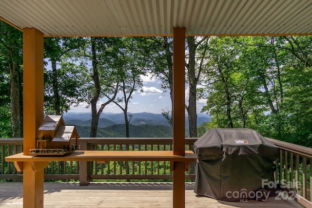 wooden deck featuring a mountain view and grilling area