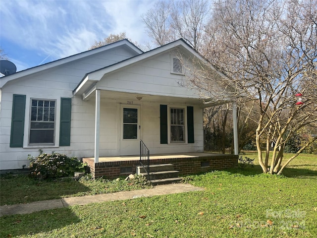 bungalow-style home with a front yard and a porch