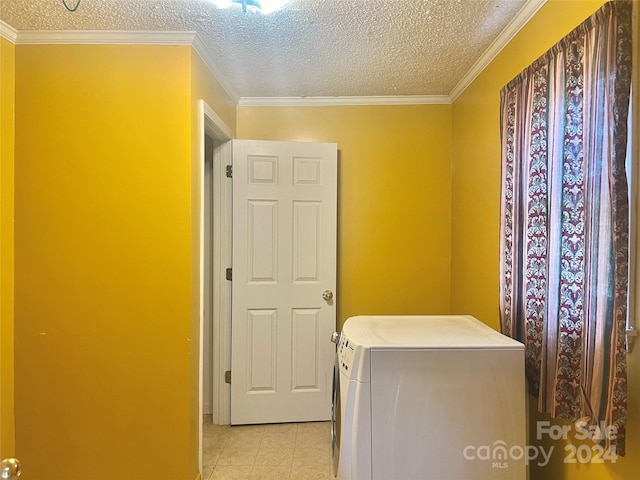 laundry area with crown molding, light tile patterned flooring, a textured ceiling, and washer / dryer