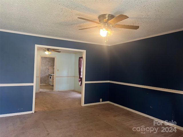 empty room featuring ceiling fan, crown molding, carpet floors, and a textured ceiling