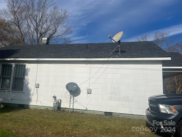 view of side of home with a lawn