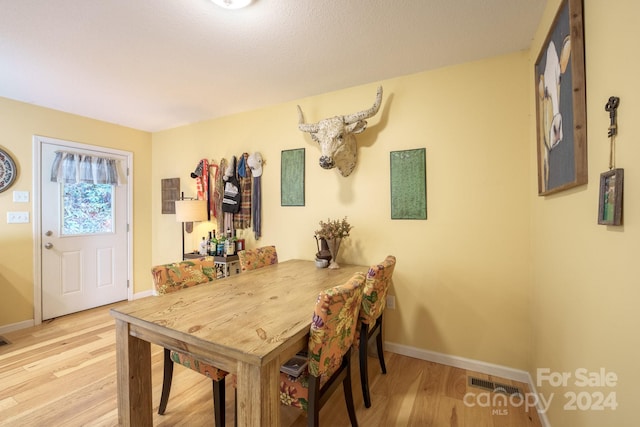 dining space with light hardwood / wood-style flooring