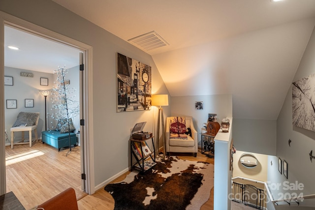 living area featuring light hardwood / wood-style flooring and lofted ceiling