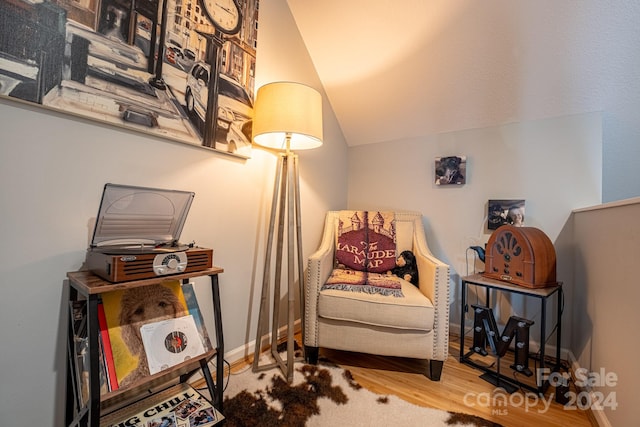 sitting room featuring hardwood / wood-style flooring and vaulted ceiling