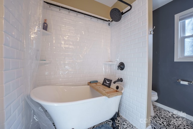 bathroom with tile patterned floors, a bathtub, and toilet