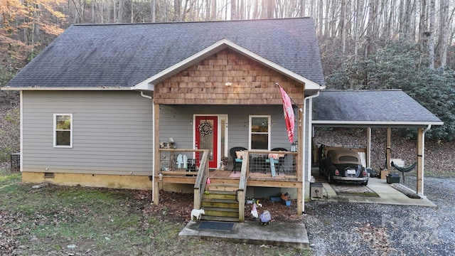 view of front of house featuring covered porch and a carport