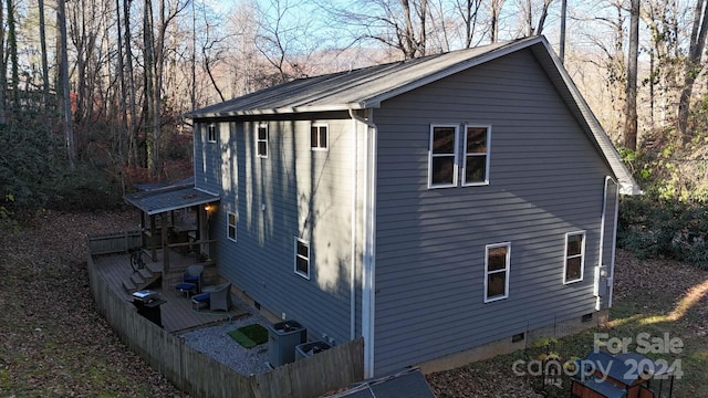 view of side of property featuring central air condition unit