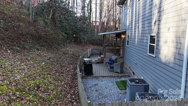 view of yard with central AC unit and a wooden deck