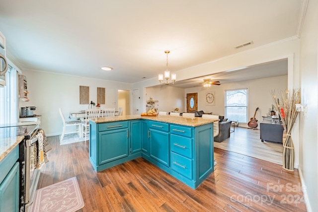 kitchen featuring decorative light fixtures, dark hardwood / wood-style floors, a kitchen island, and blue cabinets