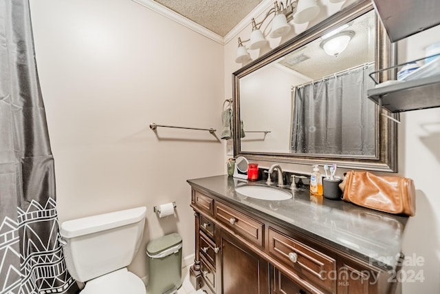 bathroom with vanity, toilet, ornamental molding, and a textured ceiling