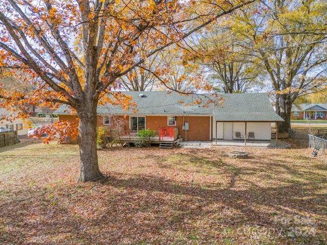 back of property featuring a yard, a patio, and a deck