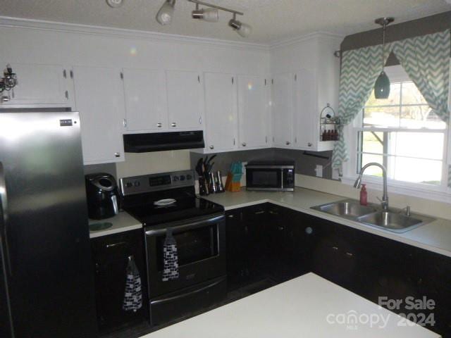 kitchen with appliances with stainless steel finishes, crown molding, sink, white cabinetry, and hanging light fixtures