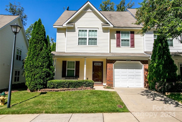 view of front of house with a front yard and a garage