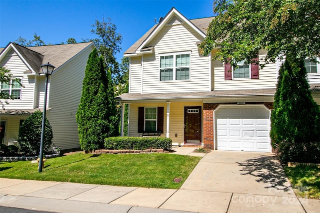 view of front of property featuring a front yard and a garage