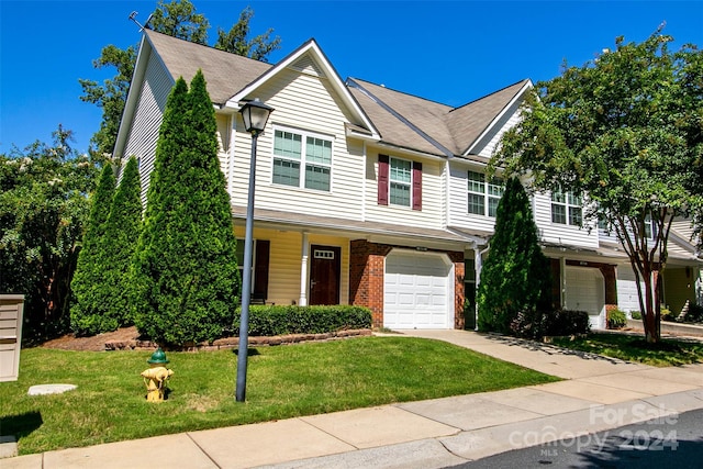 view of front of property with a front lawn and a garage