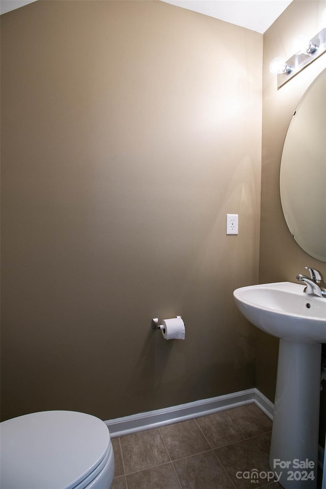 bathroom with tile patterned floors, toilet, and sink