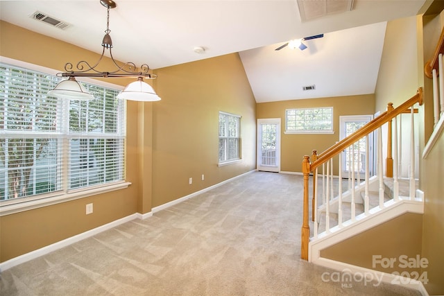 carpeted empty room featuring lofted ceiling