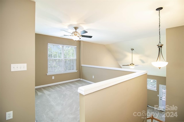 hallway featuring carpet flooring and lofted ceiling