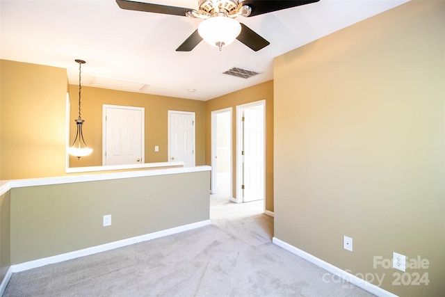 empty room with light colored carpet and ceiling fan