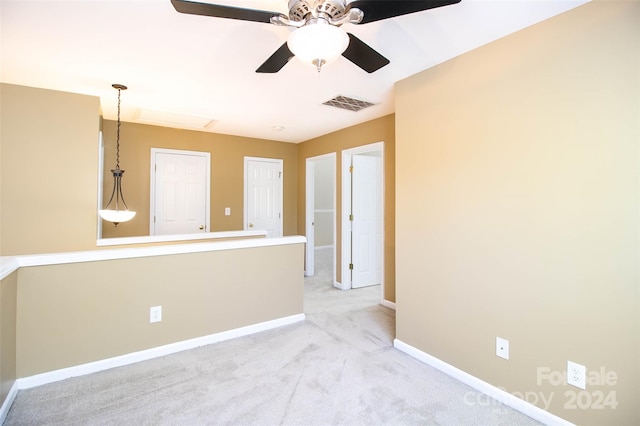 carpeted spare room with ceiling fan