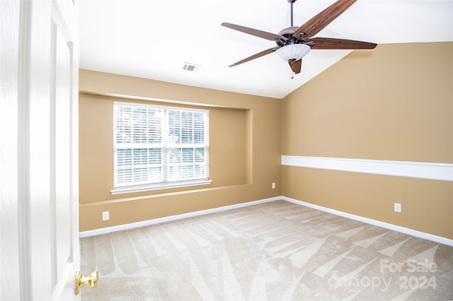 unfurnished room with ceiling fan, carpet, and vaulted ceiling