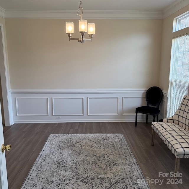 unfurnished room with dark hardwood / wood-style flooring, crown molding, and a chandelier