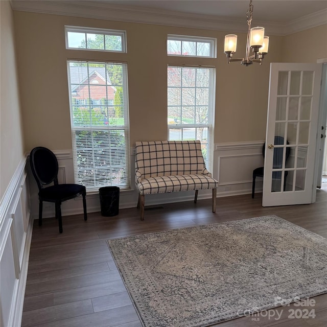 unfurnished room with crown molding, wood-type flooring, and a notable chandelier