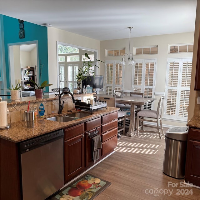 kitchen featuring sink, pendant lighting, a chandelier, dishwasher, and light hardwood / wood-style floors