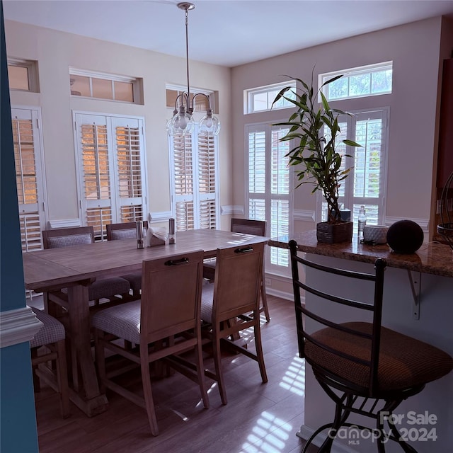 dining room with light hardwood / wood-style flooring and a notable chandelier