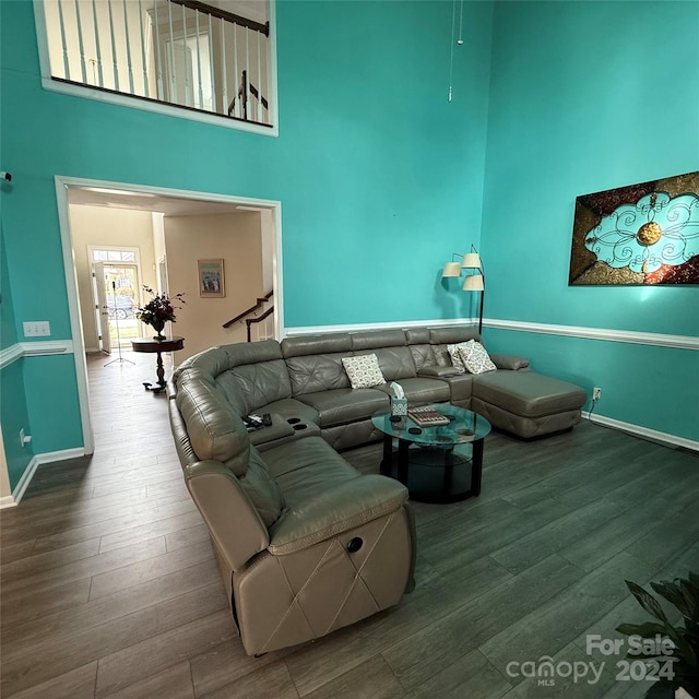 living room featuring a high ceiling and hardwood / wood-style flooring